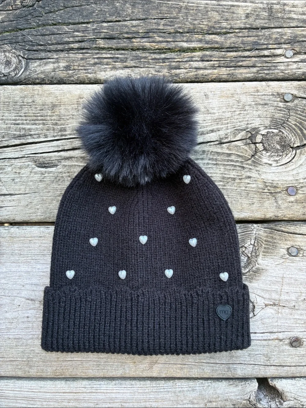 Madden Girl Black Pom-Pom Beanie with Heart Studs